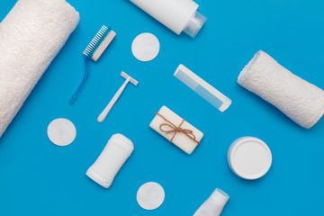 Body and skin hygienic care toiletry products, in white packaging on a blue background. Flat lay. Copy space