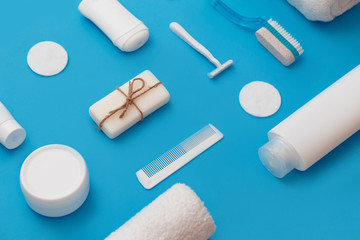 Body and skin hygienic care toiletry products, in white packaging on a blue background. Flat lay. Copy space