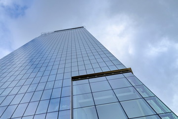 Plakat Glass skyscrapers of irregular shape. Bottom view. Abstract architectural detail of corporate building suitable as background