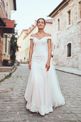 Beautiful young bride on a walk in wedding dress