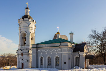 2019.02.19, Moscow, Russia. Bell tower near from Voznesenskaya Church on background of blue sky, winter snowy landscape. World Heritage Sites in Russia.