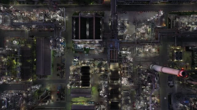 Aerial view oil and gas industrial, Refinery factory oil storage tank and pipeline steel at night