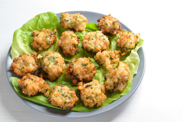 fried prawn heaps with garlic and spring onions, appetizer finger food for a festive party buffet on a white table, copy space