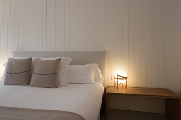 Hotel bedroom interior with double bed and complements