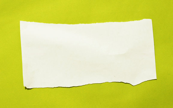 pieces of torn paper on yellow background. copy space