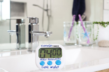 water restrictions, homemade shower timer in bathroom, used to limit shower duration due to water...