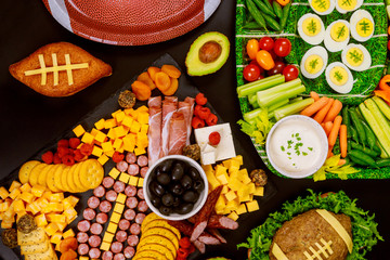 Fresh cut vegetable platter with charcuterie board for american football game party.