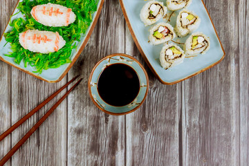 Delicious sushi and rolls with soy sauce and chopstick for american football game party.