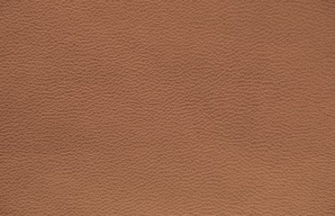 Fototapeta premium The texture of genuine leather. Impeccable and stylish background. Beautiful stylish background. Natural skin texture close up. Brown background. The structure of the leather material brown shades