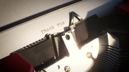 old typewriter with text thank you being revealed on white paper