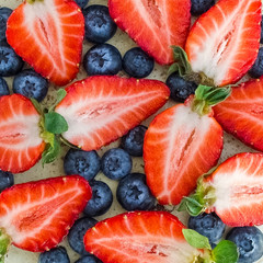 Freshly cut strawberries and blueberries. top view. background, texture