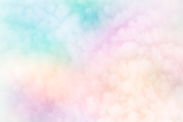 Fluffy white blurred sky clouds on abstract neon pastels of rainbow patchwork  background - Fleecy sky (Cirrocumulus - weather forecast cloud type) brings change.