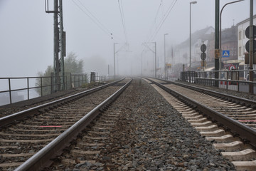 Fototapeta na wymiar A foggy station of railroad