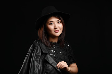 Portrait of young Asian woman on dark background