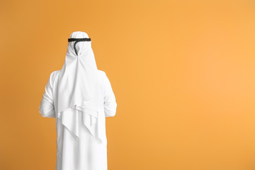 Handsome Arab man on color background, back view