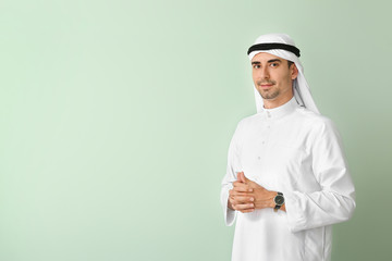 Handsome Arab man on color background