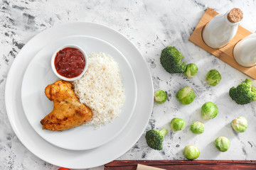 Tasty rice and chicken with sauce on white table