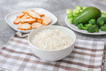 Bowl with tasty rice on table