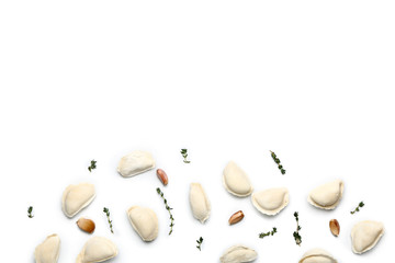 Raw dumplings with spices on white background