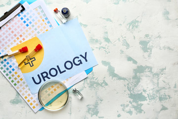 Paper sheet with text UROLOGY, Petri dish and medicines on light background