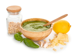 Pesto sauce with ingredients on white background