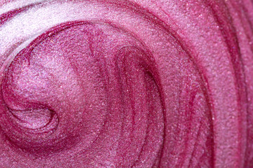 Texture of lip gloss. Smudged pink lipgloss