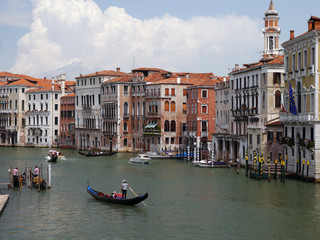 Obraz na płótnie Canvas Gondolier steering a gondola on the Grand Canal in Venice, Italy