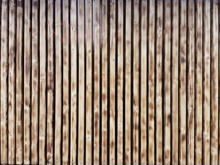 Wooden thin slats with traces of firing. Thin vertical slats.Wooden background. Abstract background. 