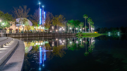 Fototapeta na wymiar CELEBRATION, ORLANDO, FLORIDA, USA. A chilly night of DECEMBER over the lake with beautiful lights reflection at Celebration City.
