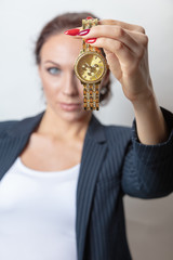 woman in a business jacket holds a red notebook in her hands. Close-up