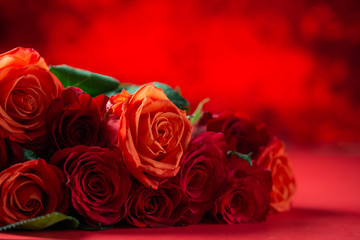 Festive bouquet with red roses on a colored background, congratulations on February 14, Valentine's Day. Love and romance