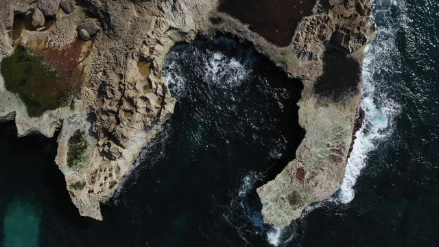 Drone shot of waves crashing in cove at Devils Tears at Lembongan Island off Bali