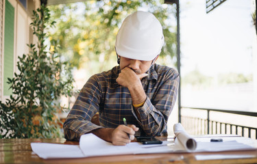 Architect asian man working Plan Construction on the blueprints