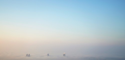 aerial panorama of clouds and roofs and sun