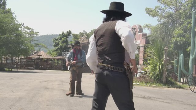 A sherriff ready to gun draw with the culprit infront of sheriff office.