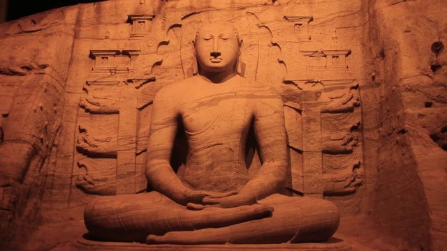 12th century Buddha statue at UNESCO world heritage site rock carving in Sri Lanka