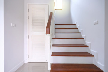 brown wooden stair and white wall in residential house