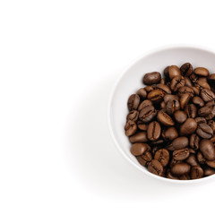 Coffee beans in a white cup. Isolated. White background.