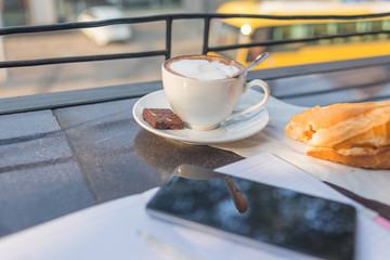 Peaceful morning with bread and hot cappuccino