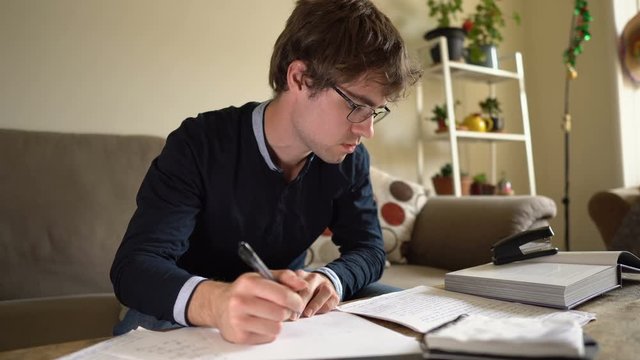 Male College Student Studying For Exam