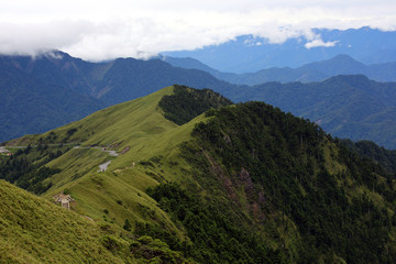 The clouds and mist often appear in the high mountains of central Taiwan. The scenery seems very magnificent and beautiful. Her name is Hehuan Mountain.