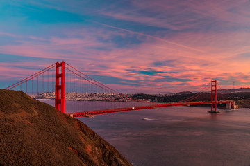 Panorama of the Golden Gate bridge with the Marin Headlands and San Francisco skyline at colorful sunset, California - obrazy, fototapety, plakaty