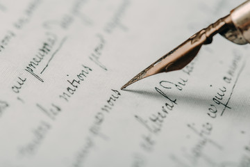 Fountain pen on an ancient handwritten letter. Old story. Retro style.