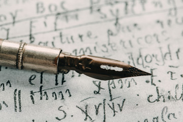 Fountain pen on an ancient handwritten letter. Old story. Retro style.