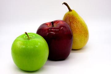 Three bright fruits: green and red apples and yellow-red pear