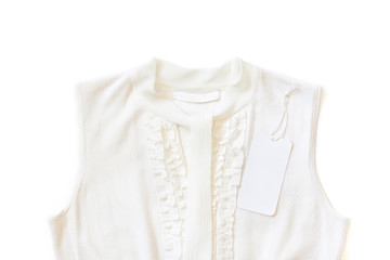 Obraz premium Brand label, blank price tag on white women's knitting clothes, elegant blouse with scarf and ruffles decor