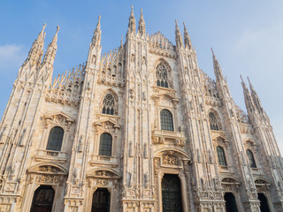 Fototapeta na wymiar Milano, Italy. The main facade of the Dome, famous Cathedral in Milan. Duomo in Italian. The church is a main landmark of the town