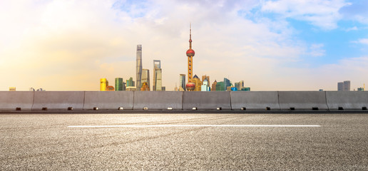 Fototapeta premium Panorama of empty asphalt road and city skyline landscape at sunset in Shanghai