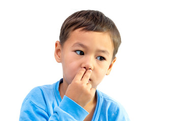 Boy with fingers rubbing his nose on a white background
