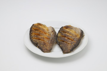 Crispy Gourami fish on white plate on white background